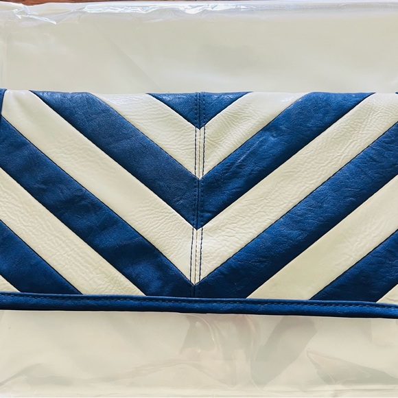 Blue and cream clutch with vibrant yellow interior lining. Button closure - Picture 1 of 8